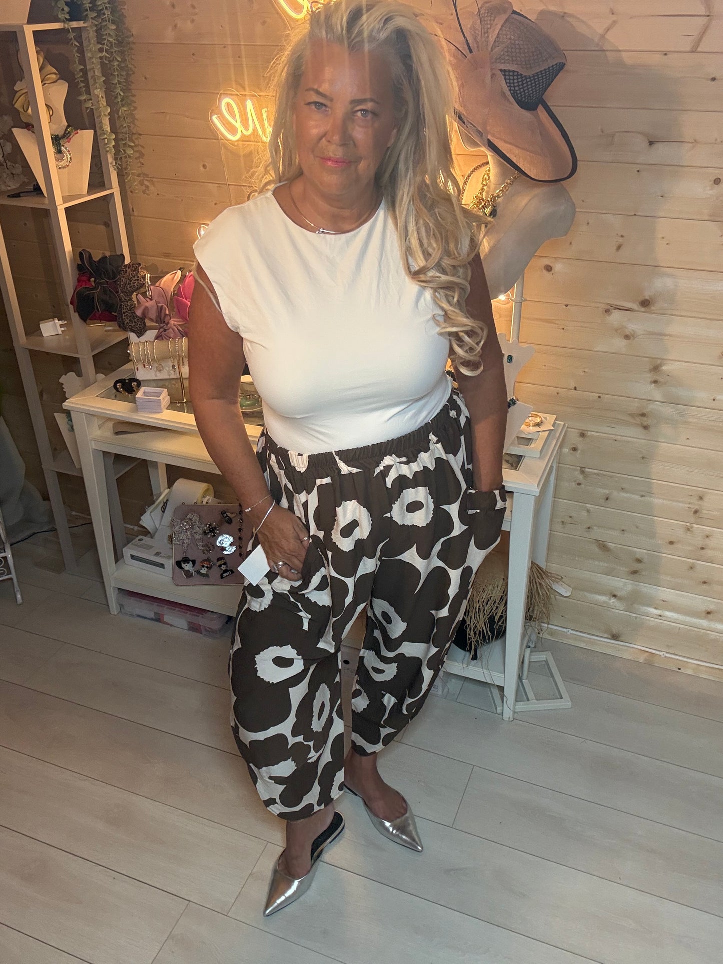 Red floral oversized slouch trousers – full length view showing relaxed silhouette and deep pockets