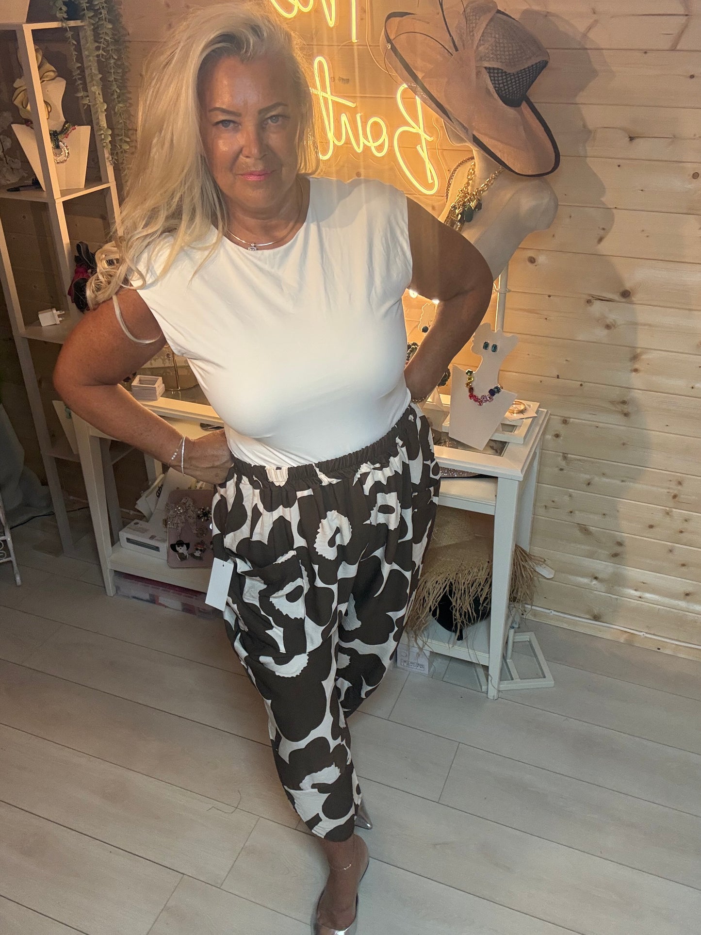 Mocha and cream bold floral oversized pocket slouch trousers – front view, styled with white tee and silver mules