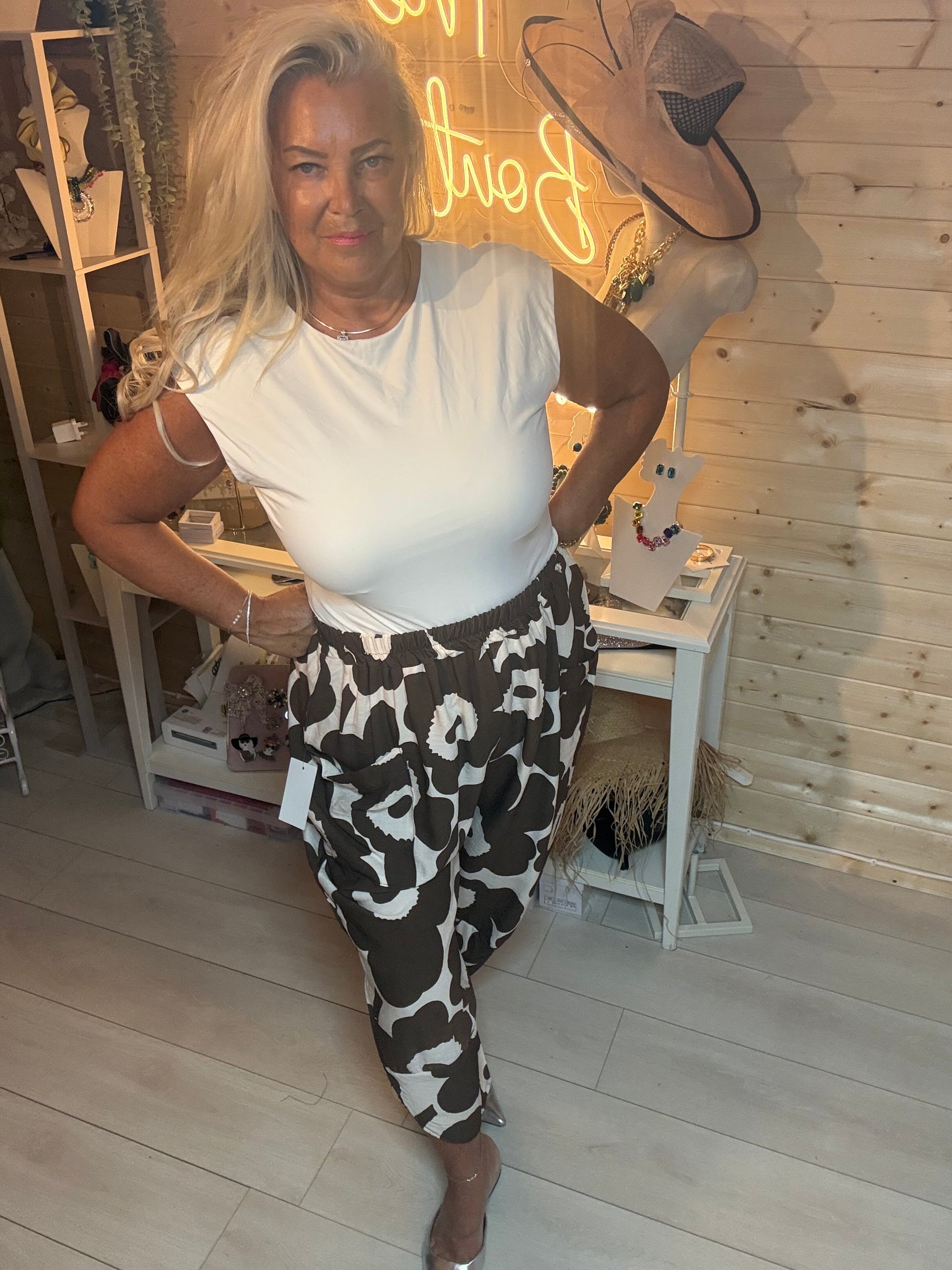 Mocha and cream bold floral oversized pocket slouch trousers – front view, styled with white tee and silver mules