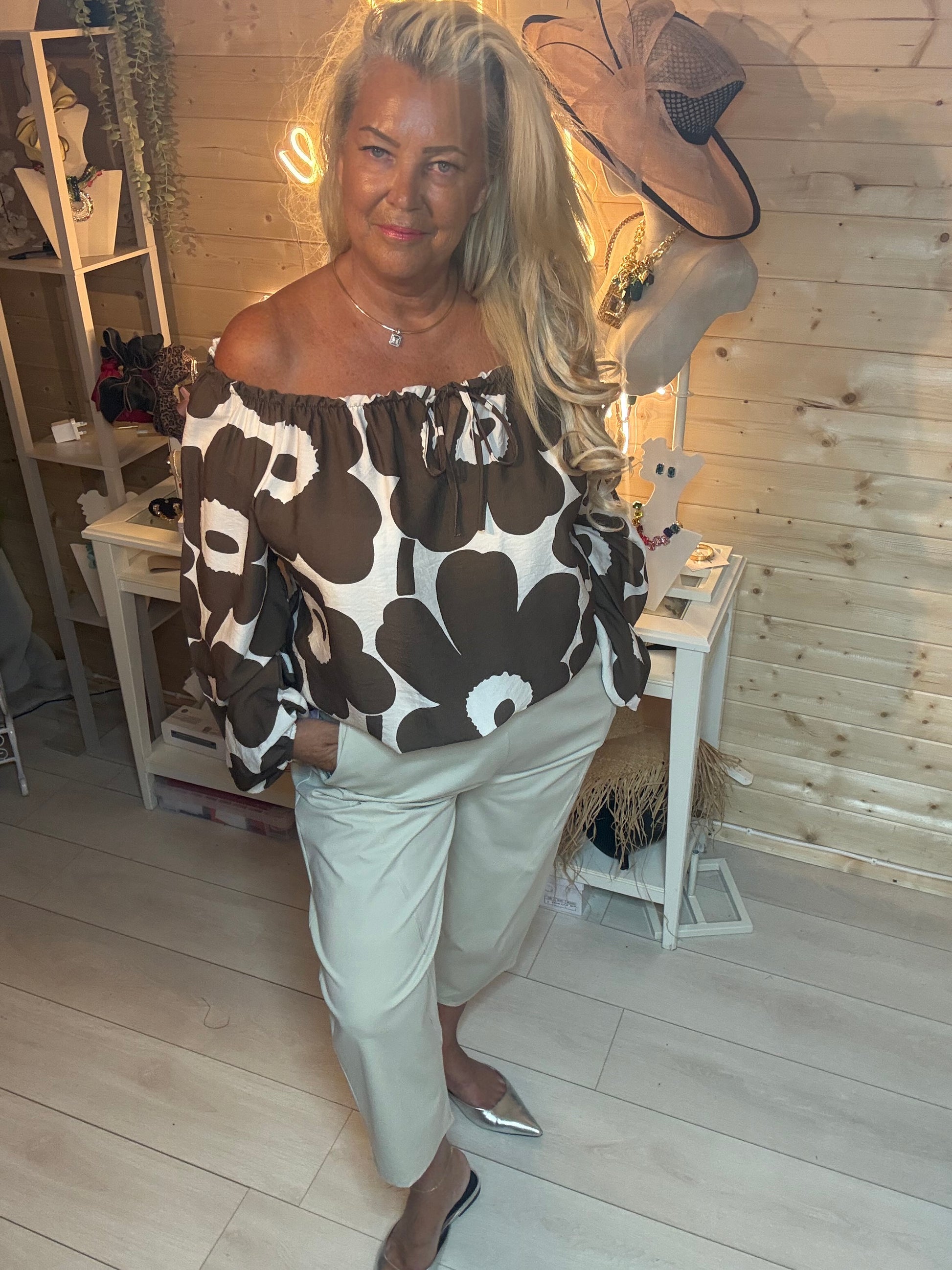 Brown and cream bold floral bardot off-shoulder top – worn off shoulder, styled with white trousers and silver mules