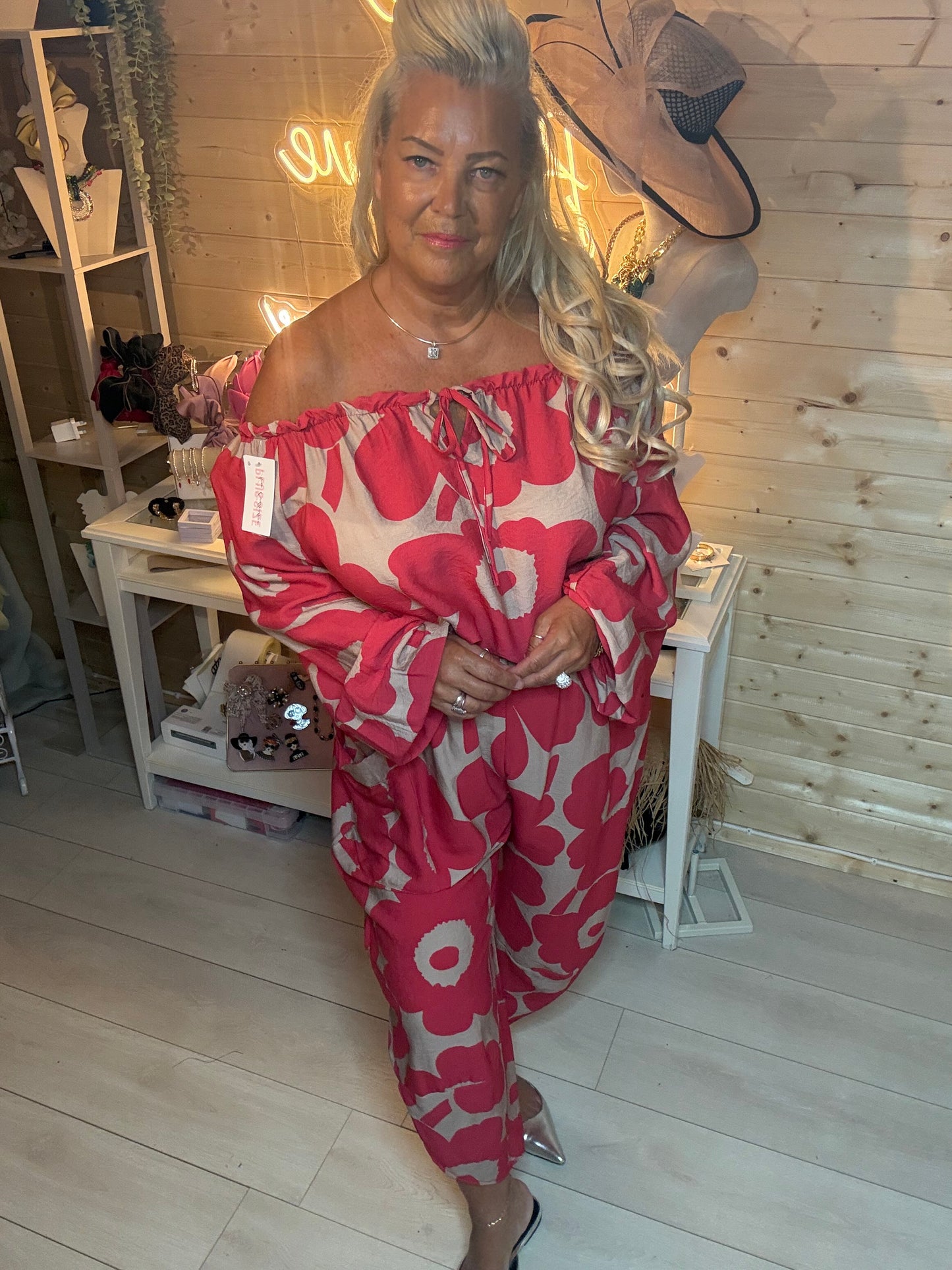 Red floral oversized trousers – side pose showing cropped length and elasticated waist