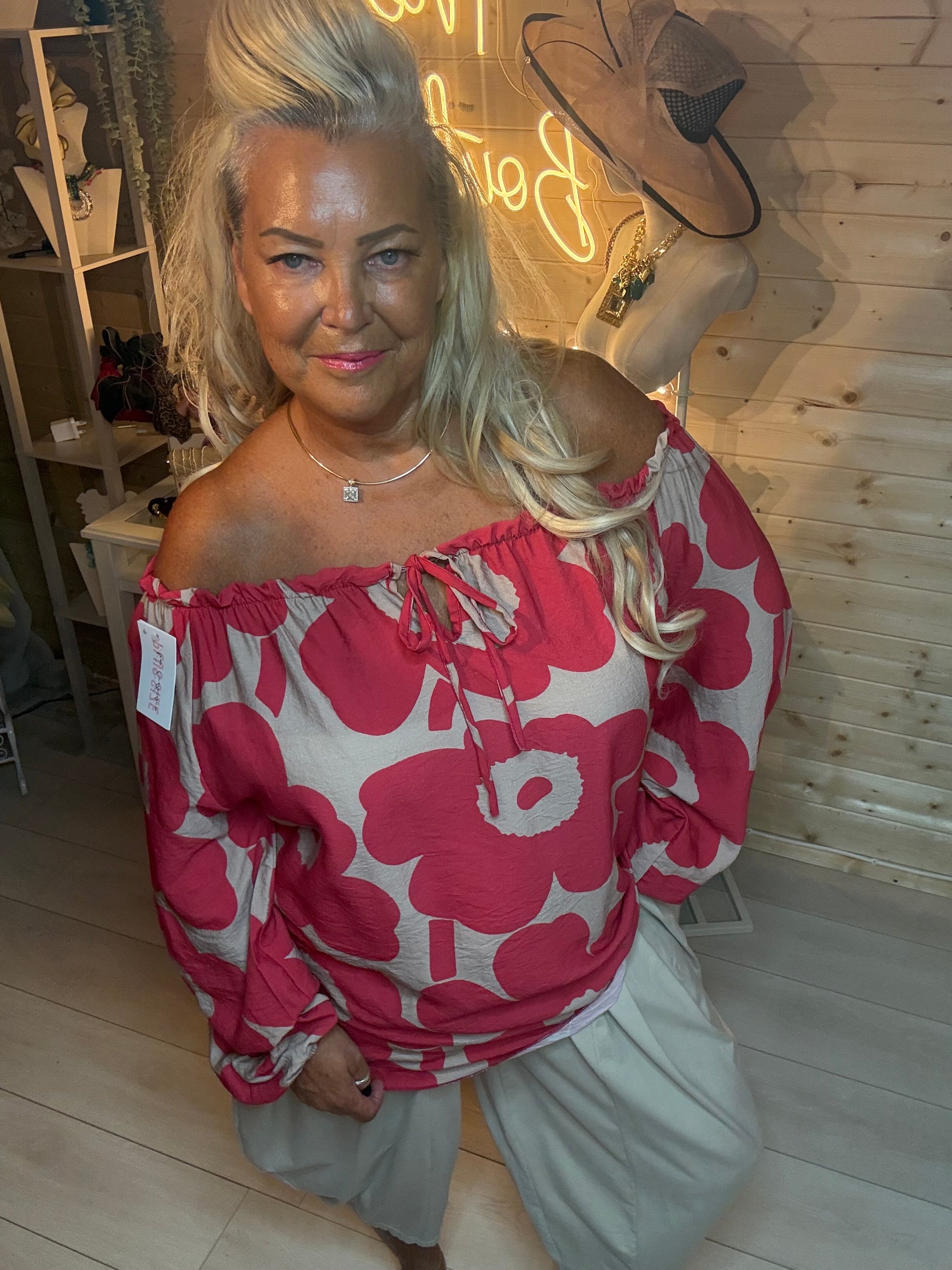 Red floral bardot top – close up showing bold poppy print, tie neckline and elasticated off-shoulder detail