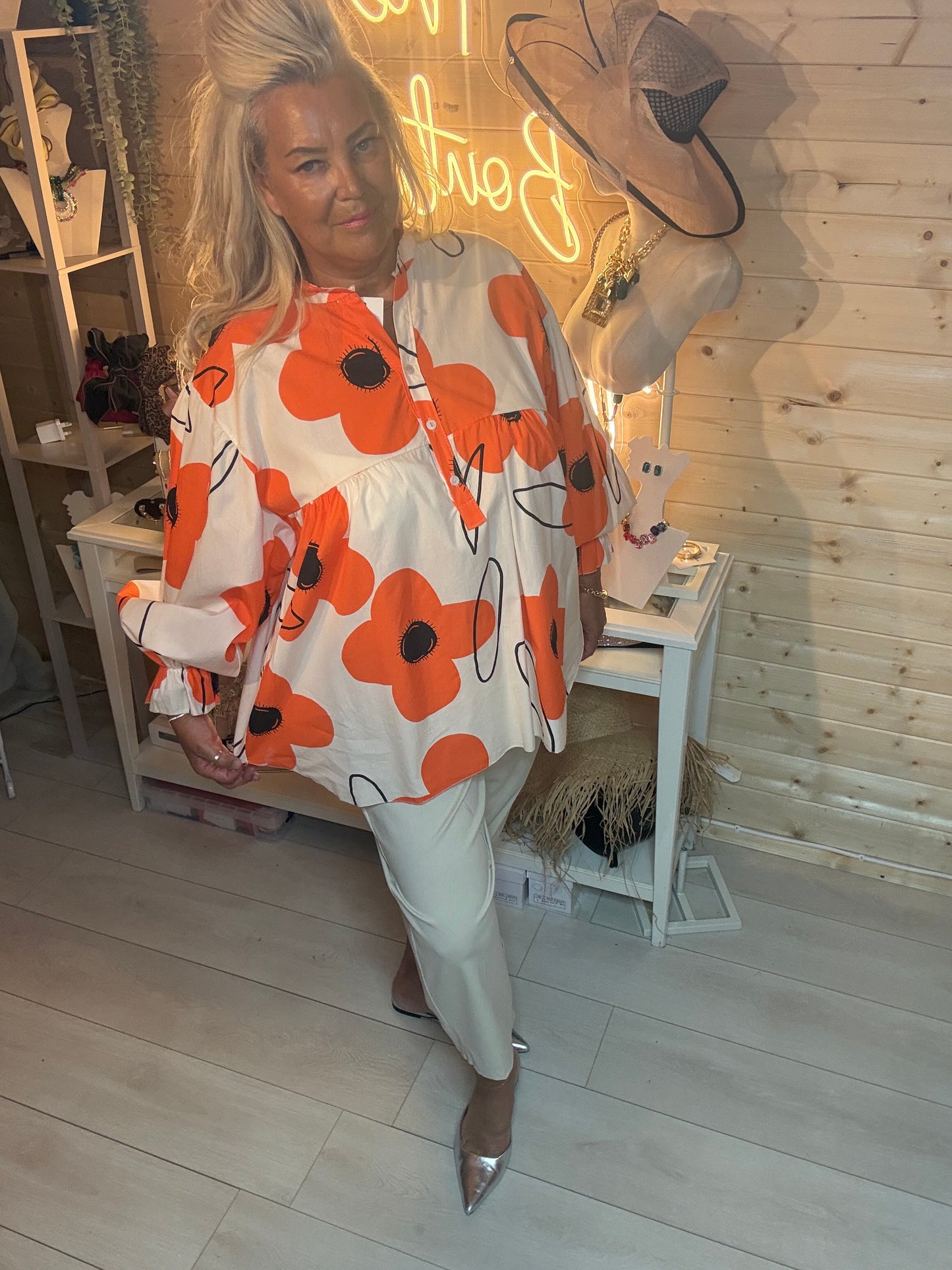 Bold orange poppy print oversized blouse – relaxed pose showing long sleeves with elasticated cuffs