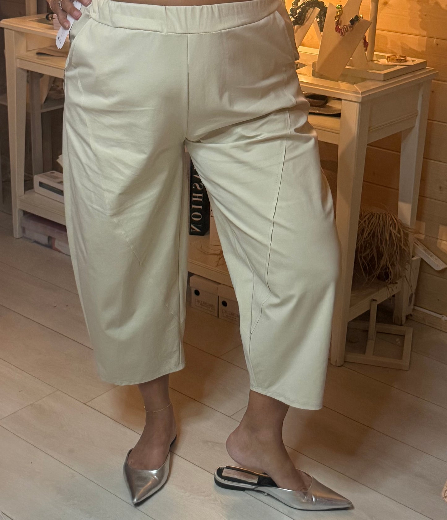 Stone cropped culotte trousers worn view showing centre front seam detail, cropped length and elasticated waist with silver mules