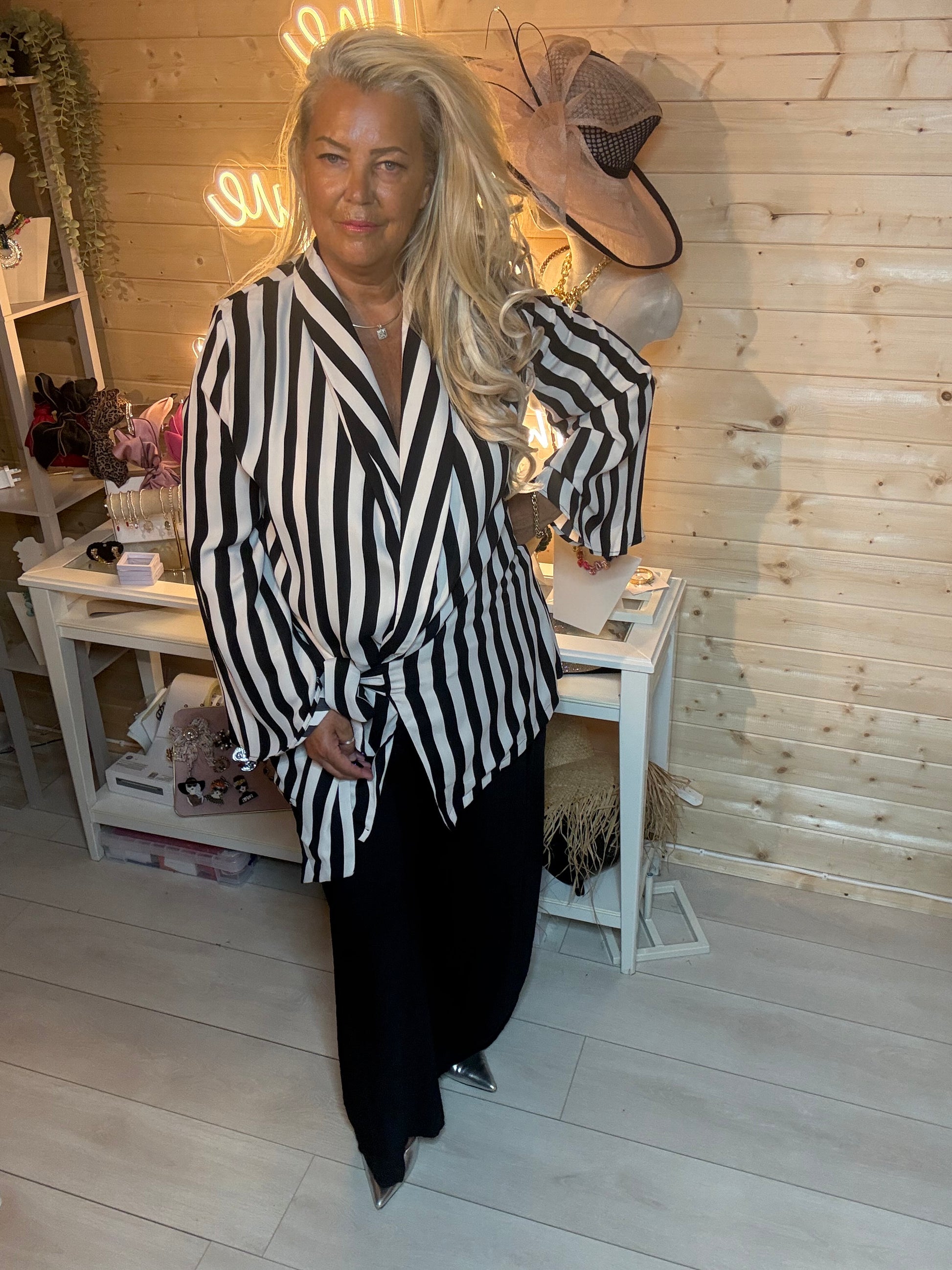 Black cream stripe wrap jacket – side view showing dramatic flared sleeves and asymmetric hem detail