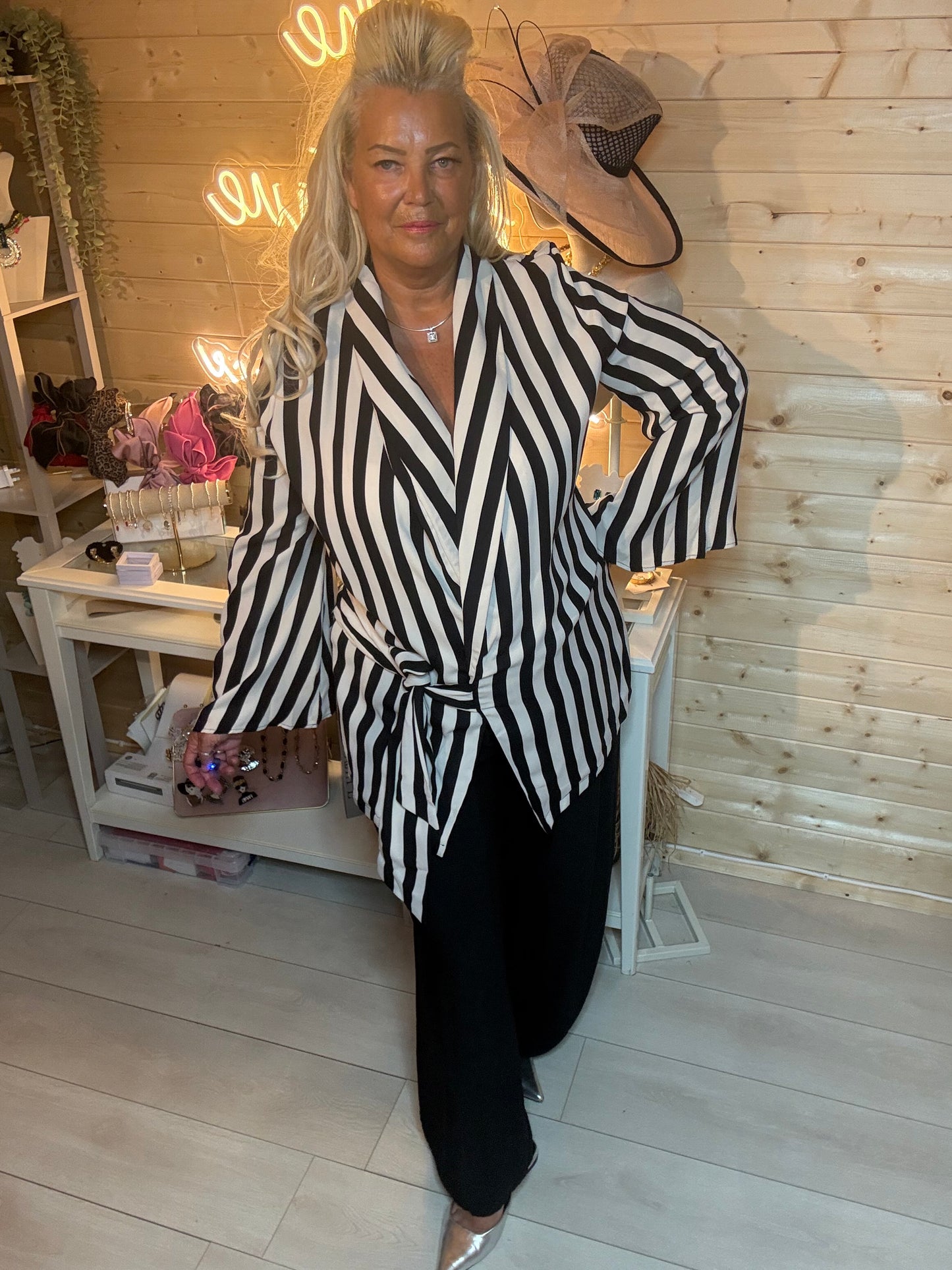 Black and cream bold stripe wrap jacket with flared sleeves and tie waist – full length front view styled with black wide-leg trousers and silver mules