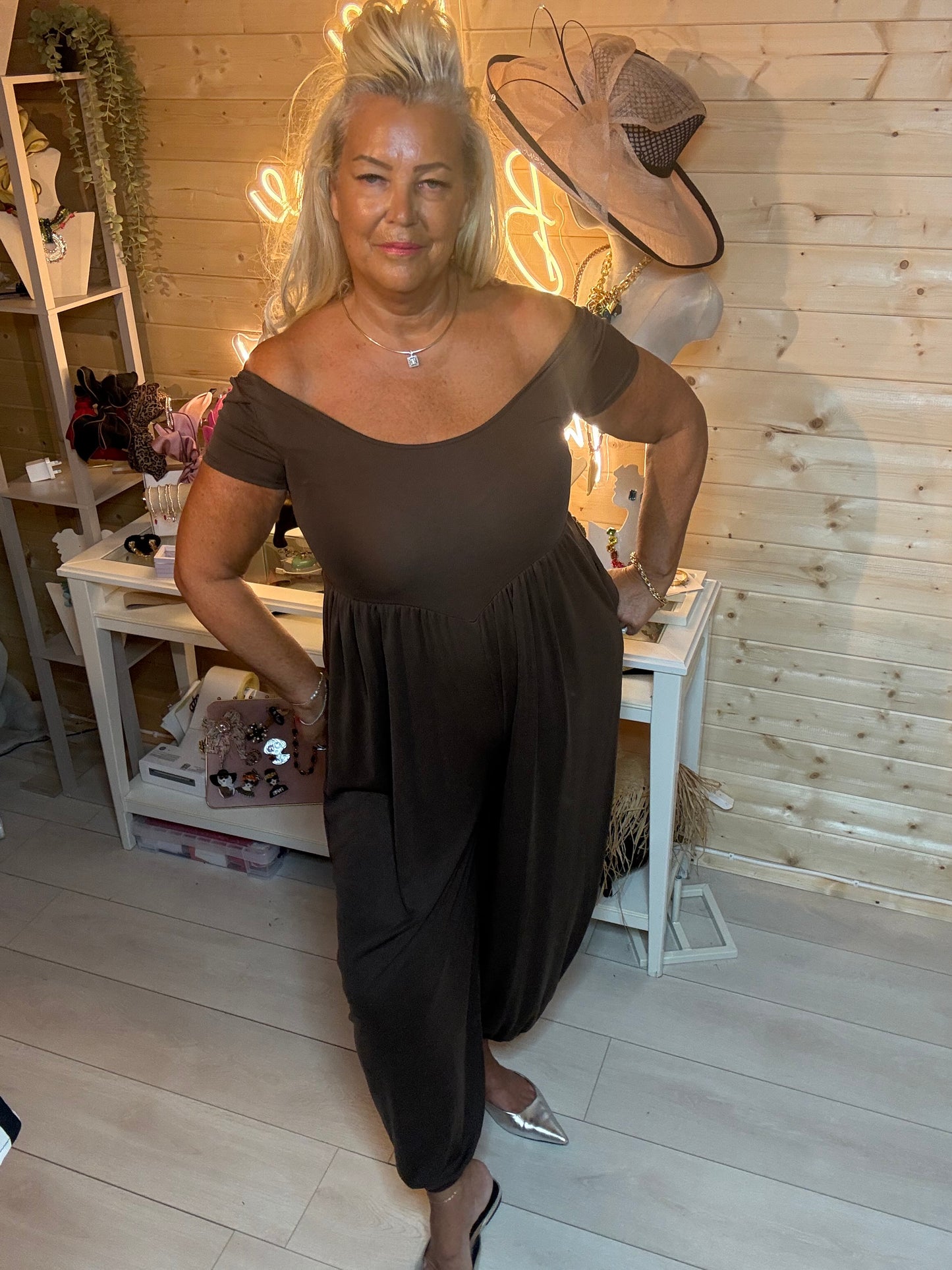 Black pocket jumpsuit – three quarter view showing scoop neckline, short sleeves and harem leg silhouette