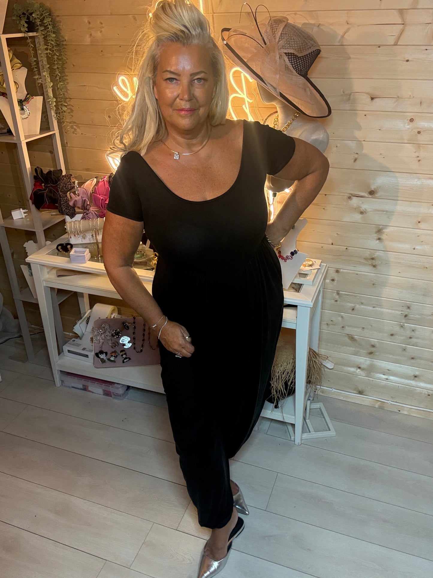 Brown harem jumpsuit – full length boutique shot showing gathered empire waist, tapered legs and silver mules
