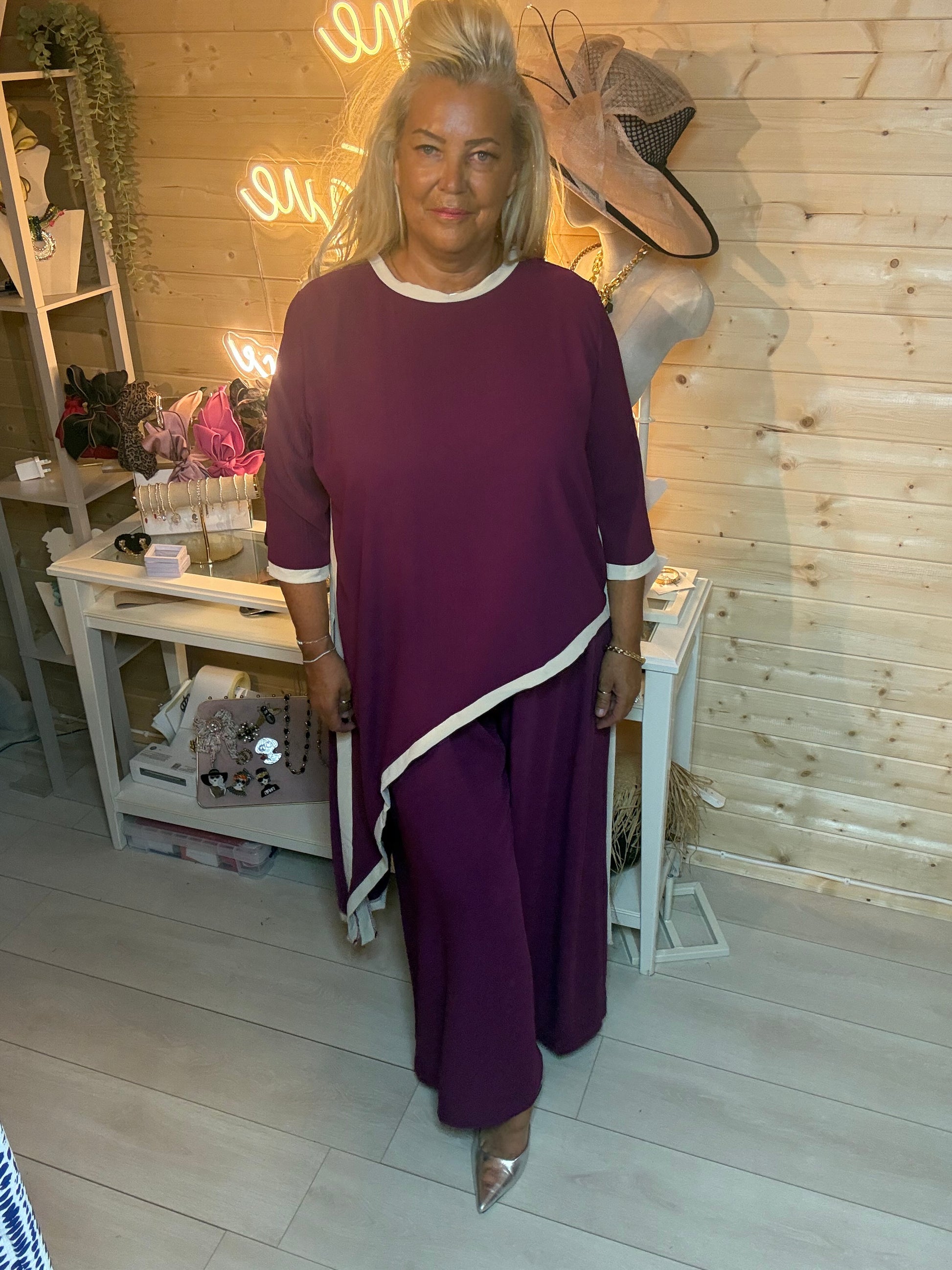 Plum co-ord set – full length front view showing oversized longline top over matching wide-leg trousers with white contrast trim and silver mules