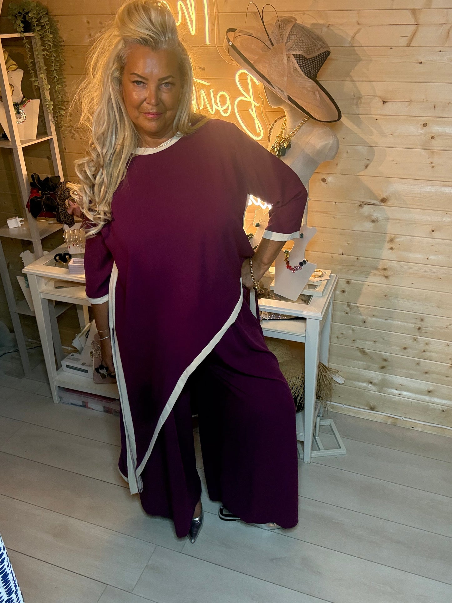 Plum asymmetric co-ord set – back view showing diagonal split hem detail, contrast trim and wide-leg trouser silhouette