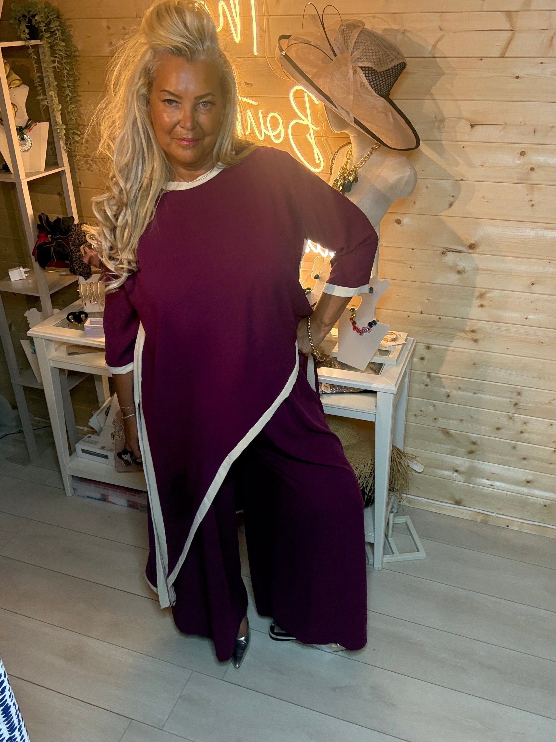 Plum asymmetric co-ord set – back view showing diagonal split hem detail, contrast trim and wide-leg trouser silhouette