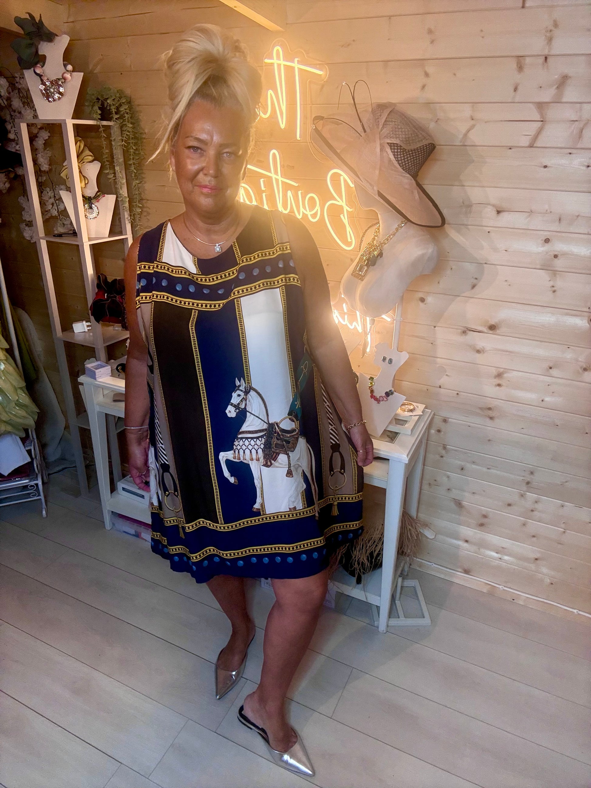 Navy equestrian scarf dress – back view showing elegant tie detail at neckline and full horse and chain print panel design