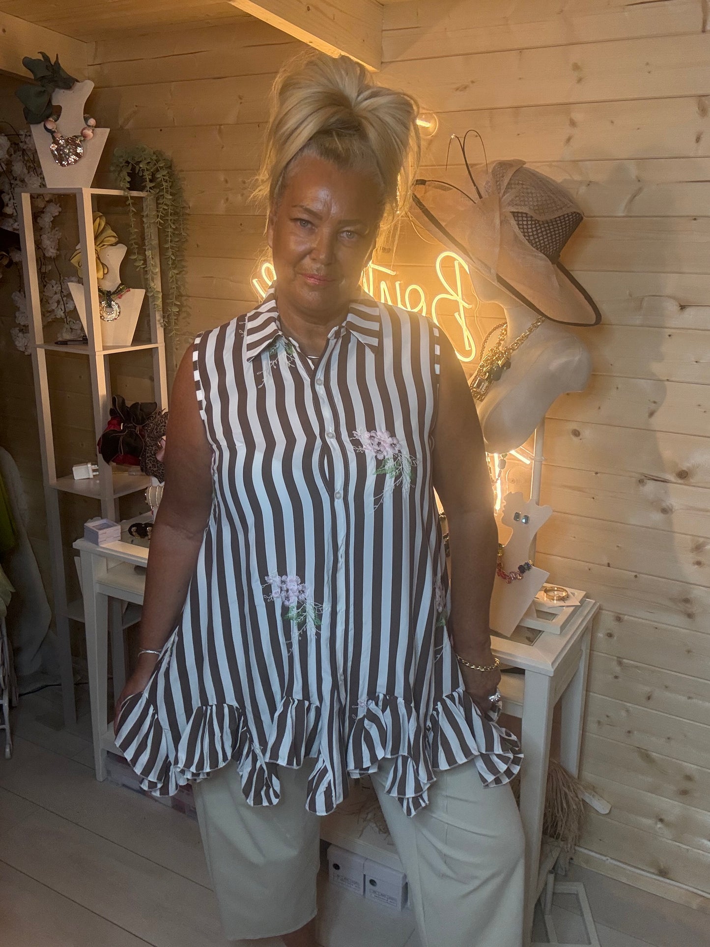 Navy stripe shirt tunic – full length three quarter view showing floaty double ruffle hem and floral embroidery detail with white trousers and silver mules