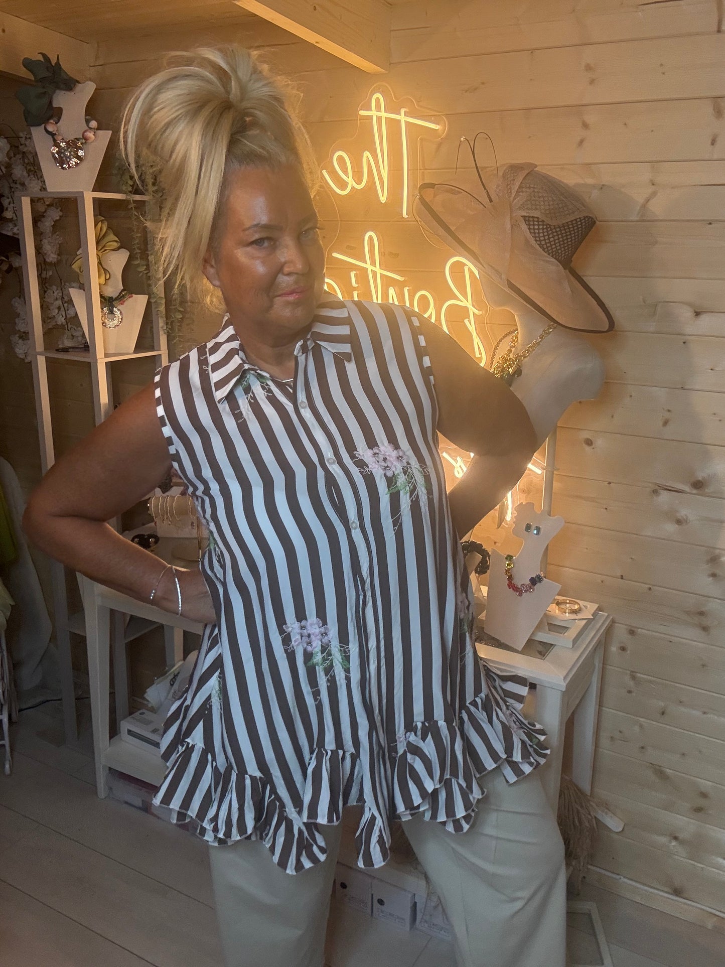 Navy and white stripe tunic – full length boutique shot showing floaty ruffle hem and floral embroidery detail styled with white trousers and silver mules