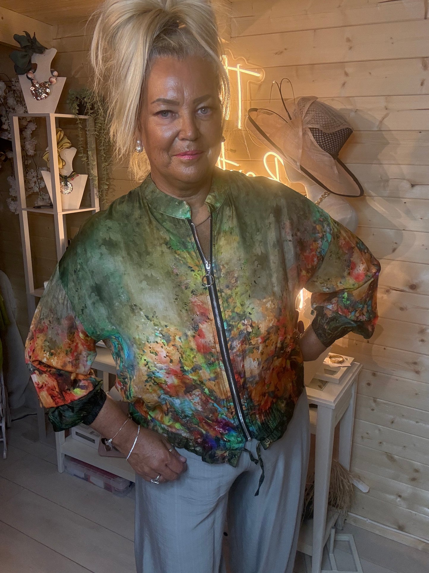 Floral print zip-up bomber jacket – close up front view showing stunning painterly floral print detail in greens, oranges, yellows and purples with zip fastening and elasticated cuffs