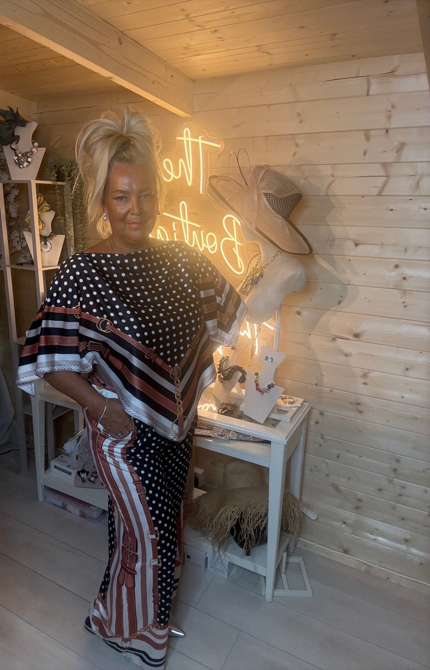 Black polka dot co-ord set – full length three quarter view showing relaxed batwing silhouette and wide-leg trousers with coordinating stripe border hem