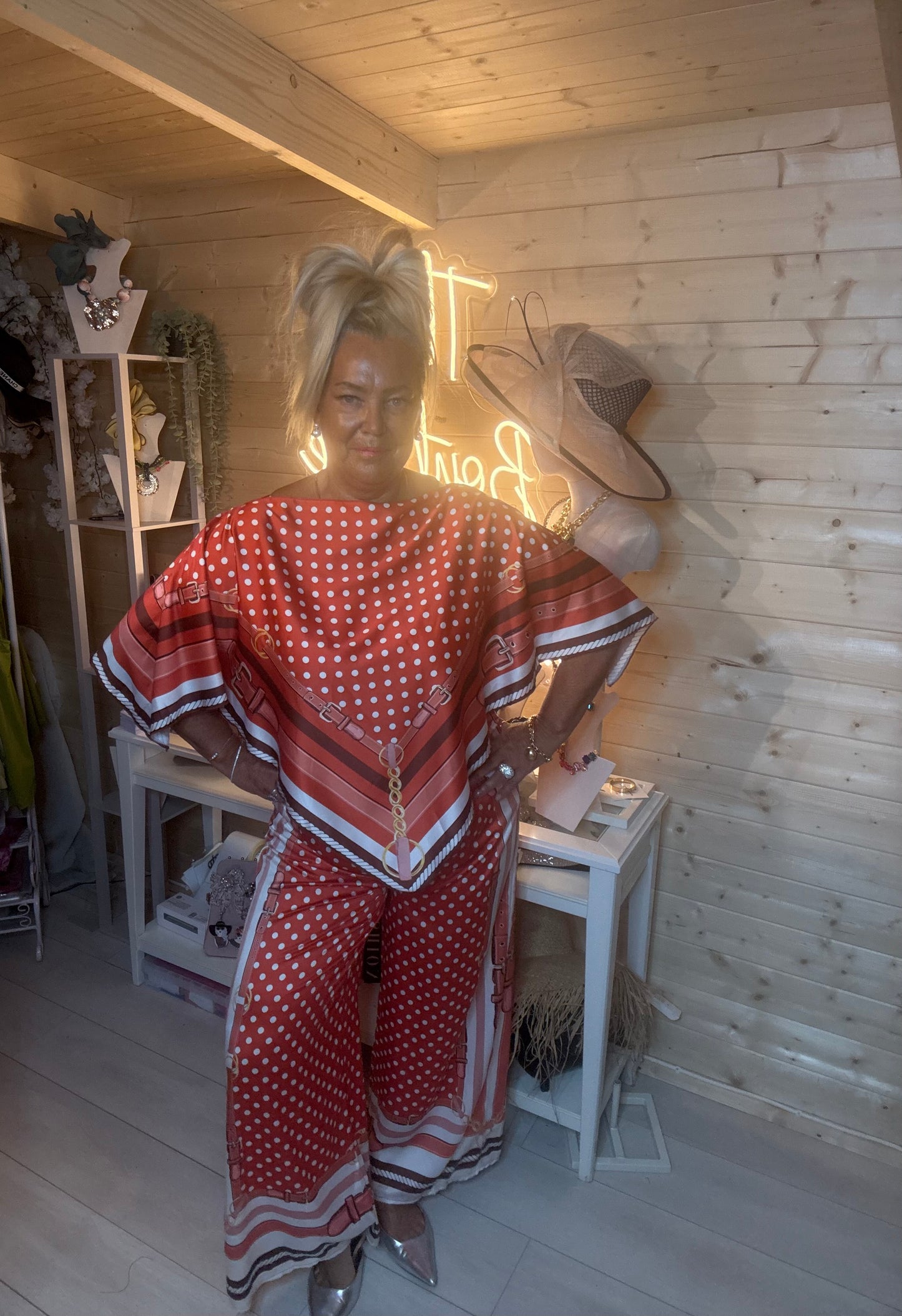 Rust polka dot scarf print co-ord – full length front view showing complete set with batwing top, chevron hem and wide-leg trousers styled with silver mules