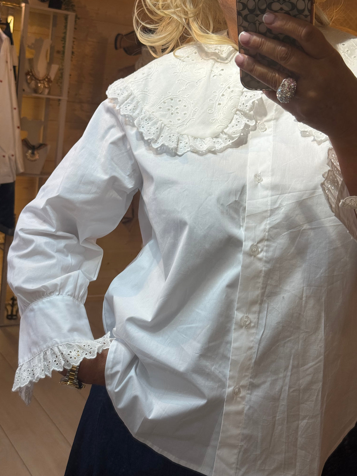 Versailles white broderie anglaise blouse full length mirror shot with dark denim trousers
