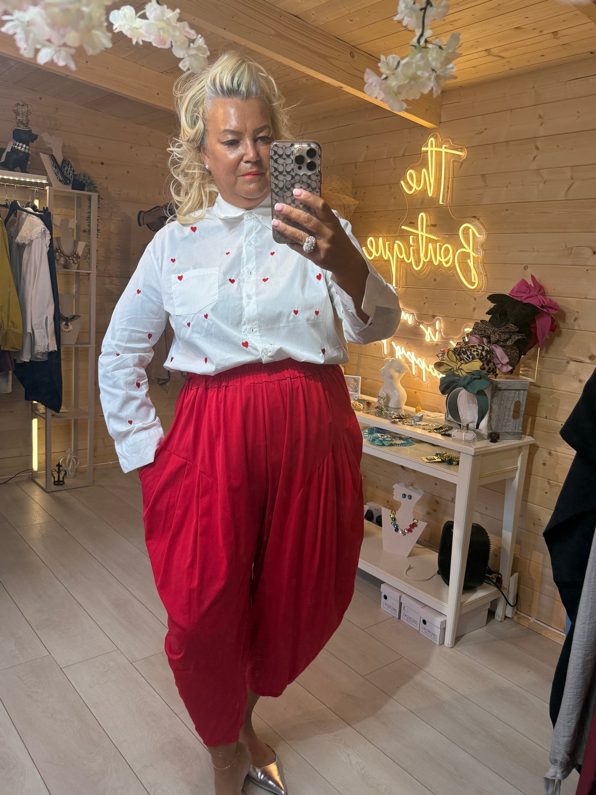 Cuore white heart print shirt full outfit with red slouch trousers and silver mule heels