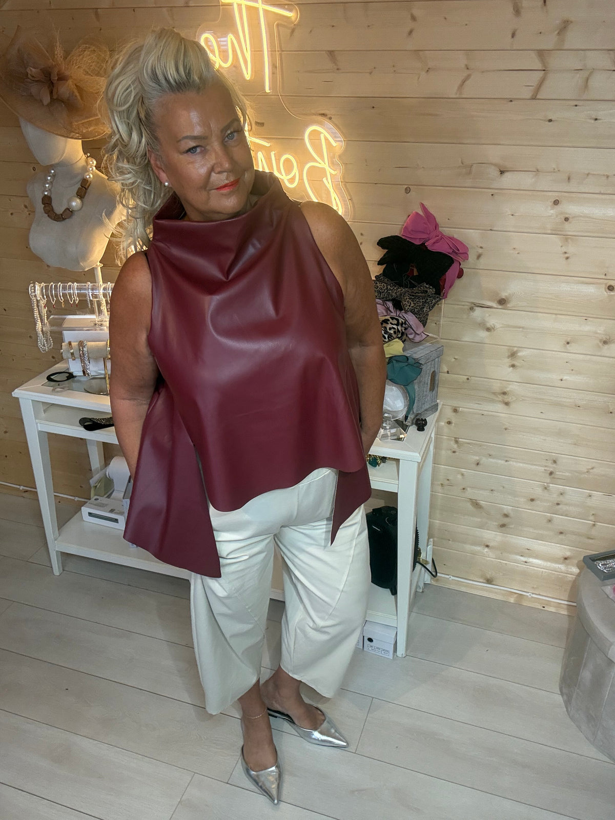 Saints faux leather cowl neck top in camel styled with stone capri trousers and silver mules front view