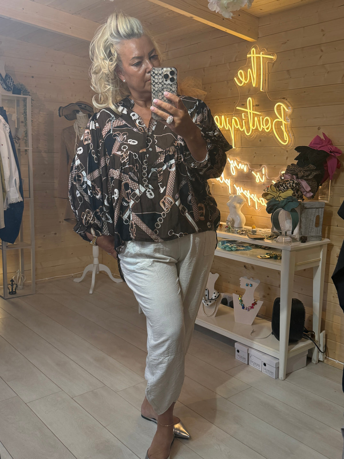 Coco blouse chocolate chain print mirror selfie front view with silver magic trousers