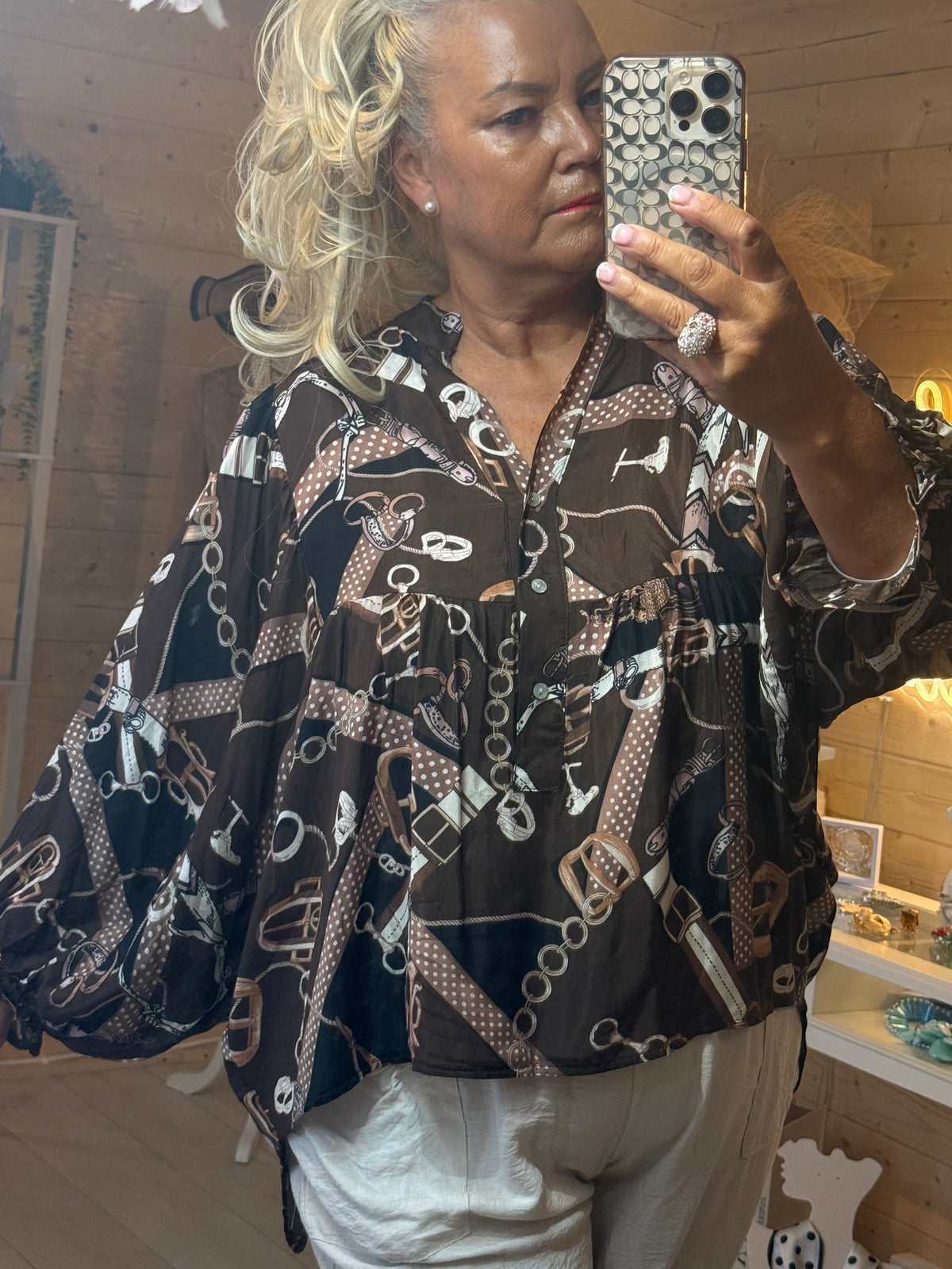 Coco blouse close up showing chocolate brown chain belt equestrian print and V-neckline detail