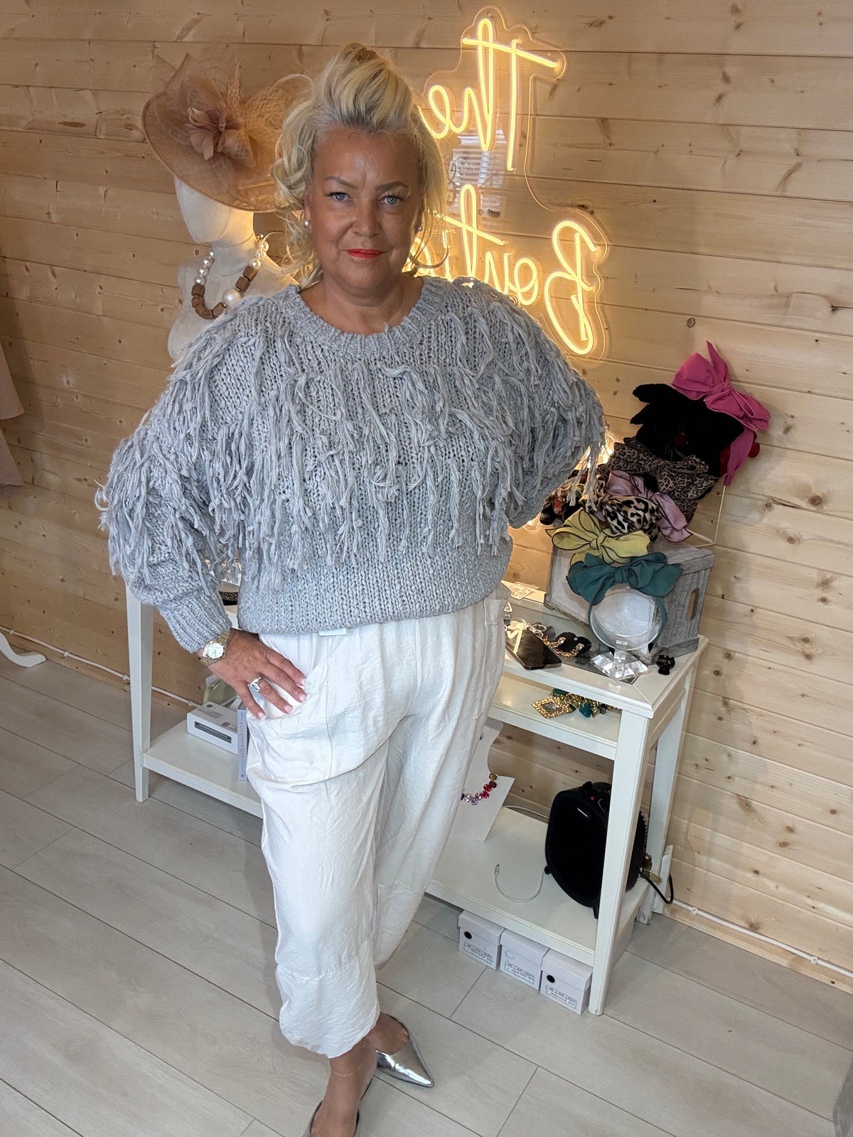 Tassle silver grey fringe knit jumper front view styled with white pocket slouch trousers and silver mules