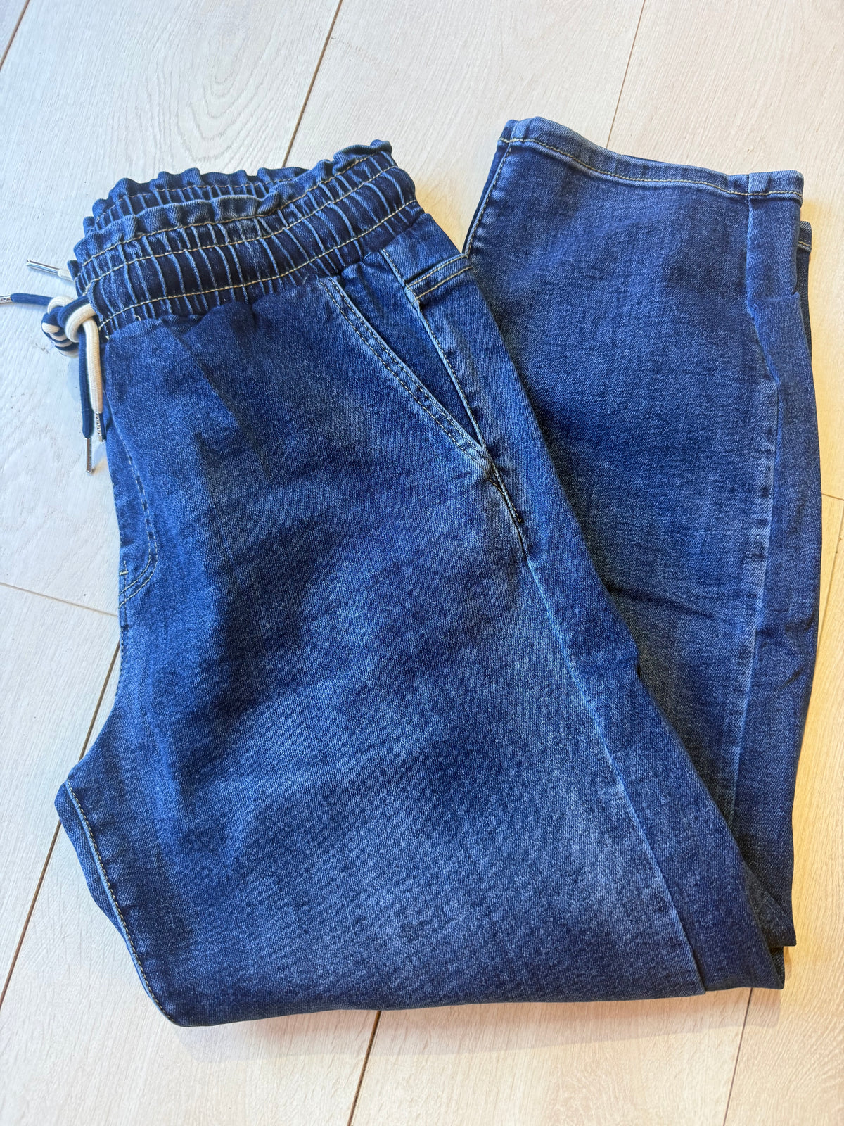 Milan dark wash barrel leg jeans, folded flat lay view
