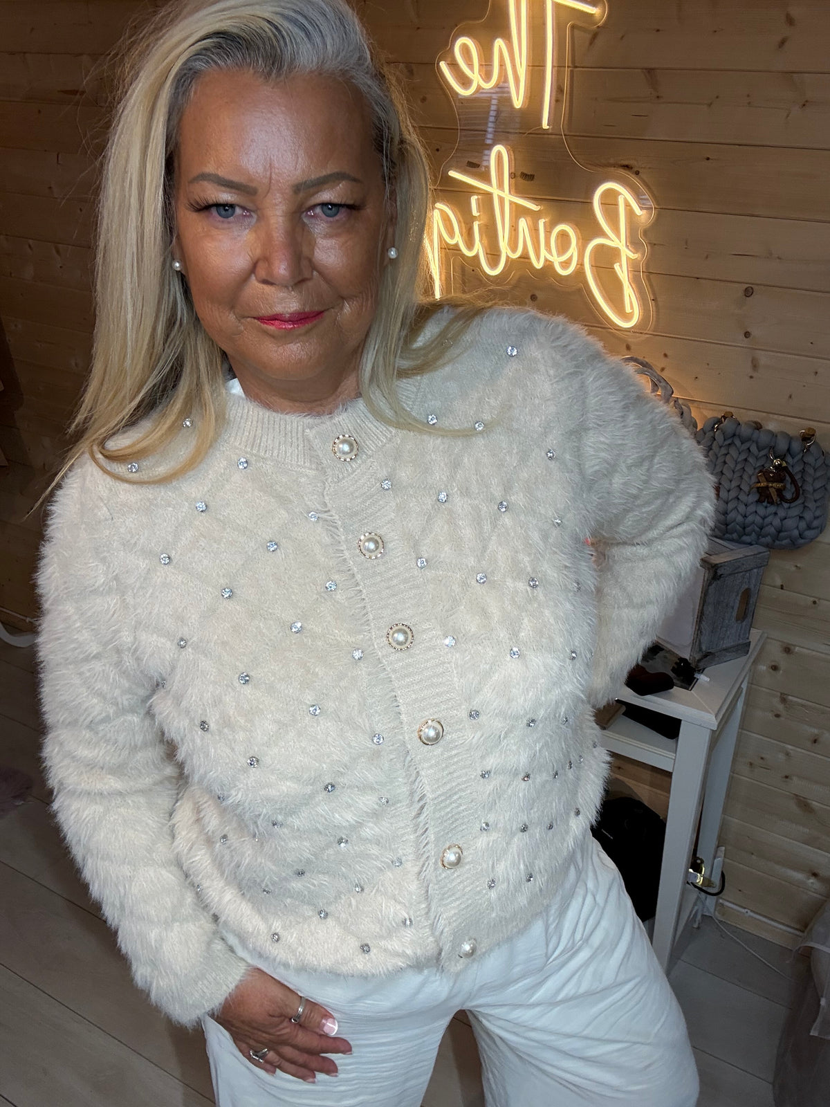 Model wearing the black embellished cardigan with light-coloured trousers