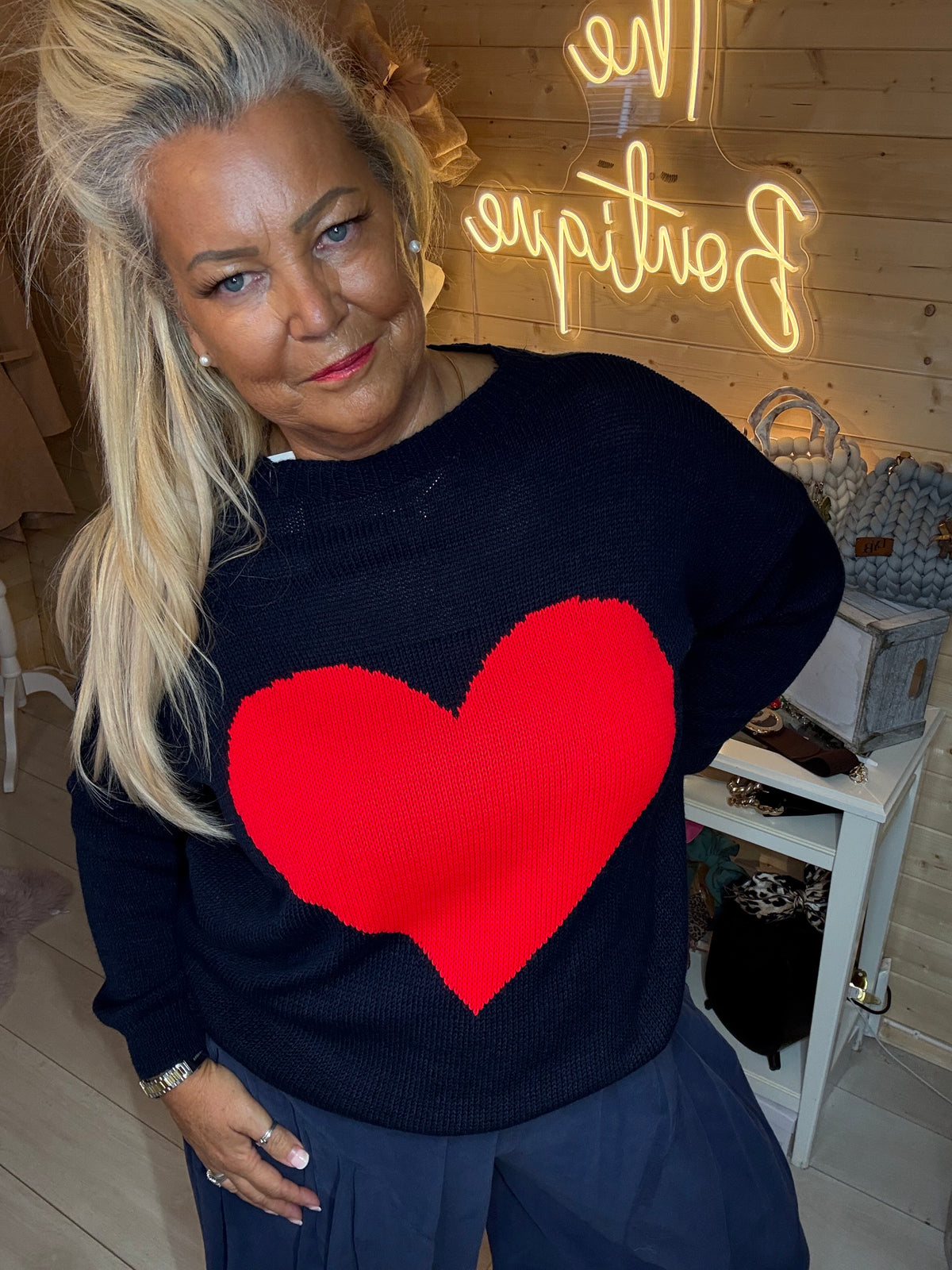 Navy jumper with a bright red heart shown with coordinating navy trousers