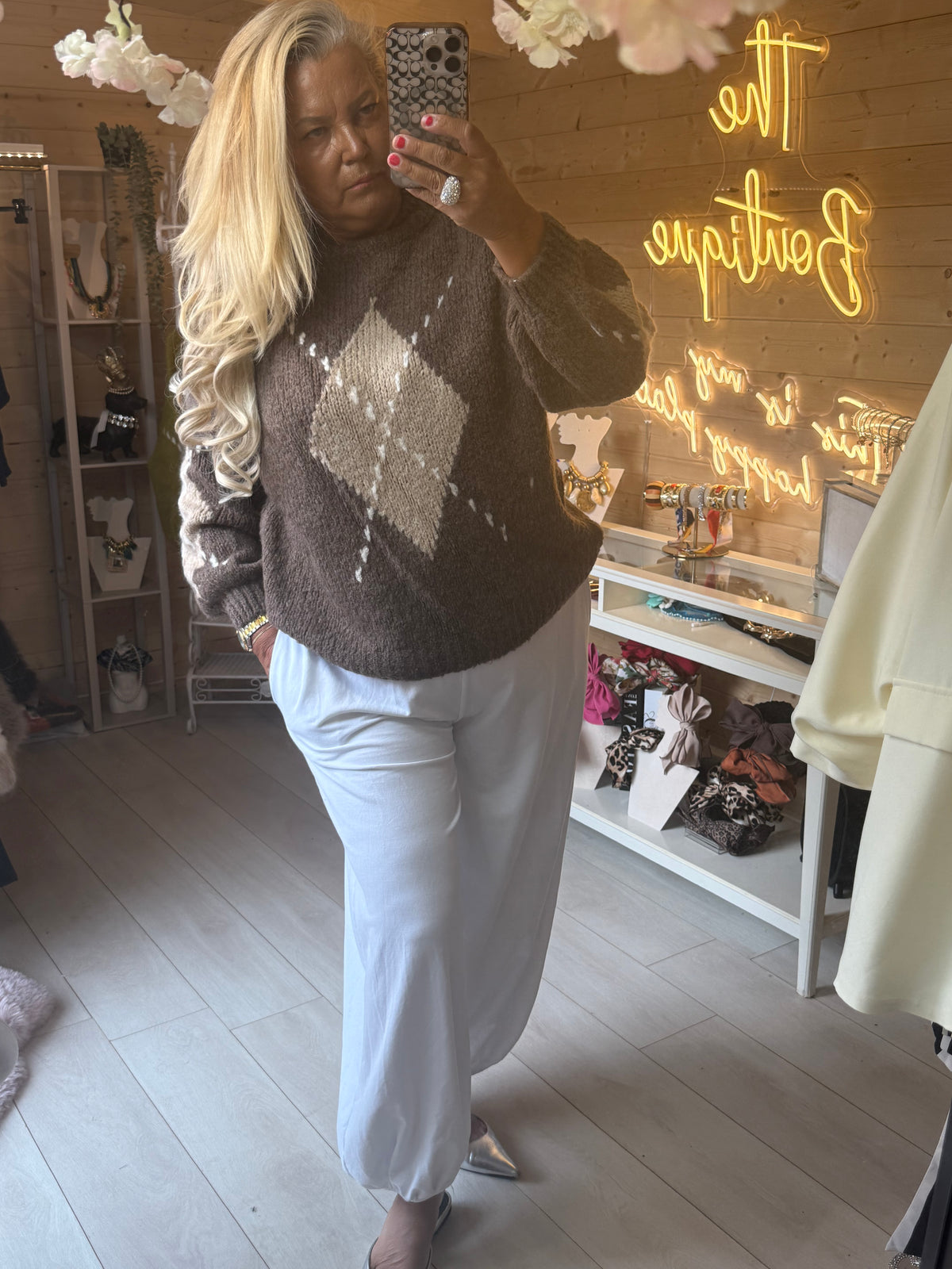 Full outfit view of Lucca Taupe diamond knit jumper with light trousers