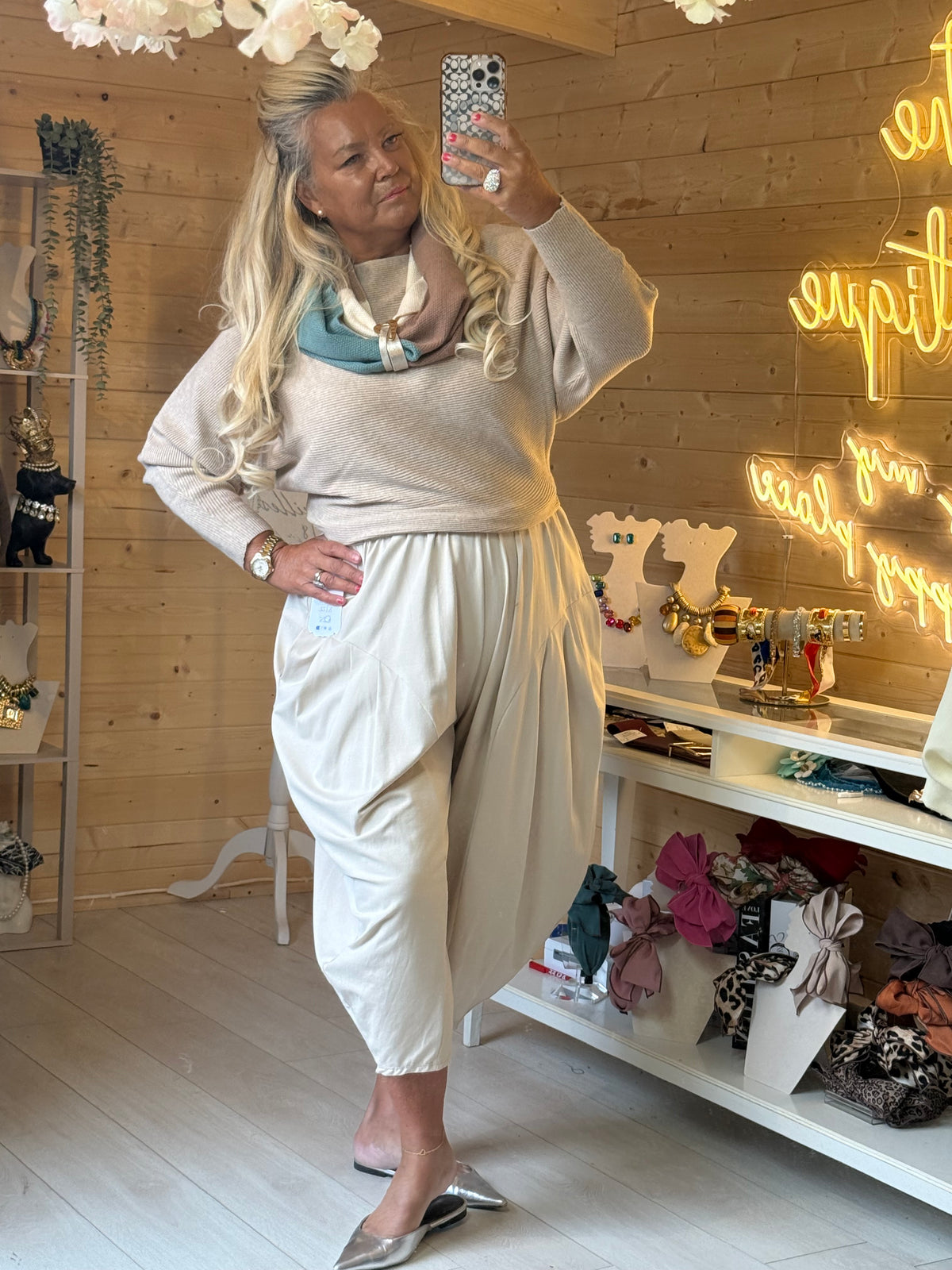 Asti Beige batwing jumper showing draped sleeves, styled with neutral trousers and a scarf sold separately