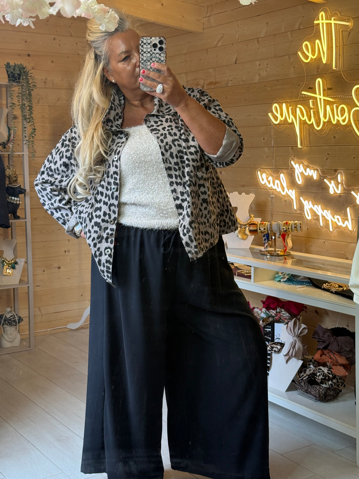 Full outfit view of Prato leopard print jacket with turned-back cuffs and black trousers