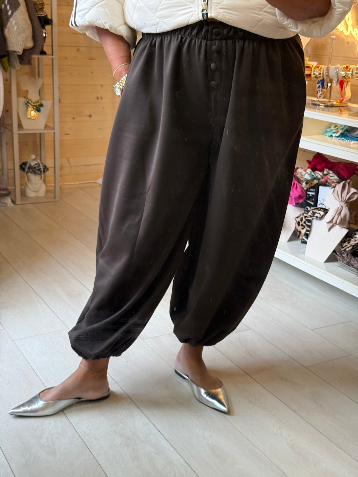 Lodi Brown balloon trousers worn with pointed flats, showing the roomy legs and gathered hems