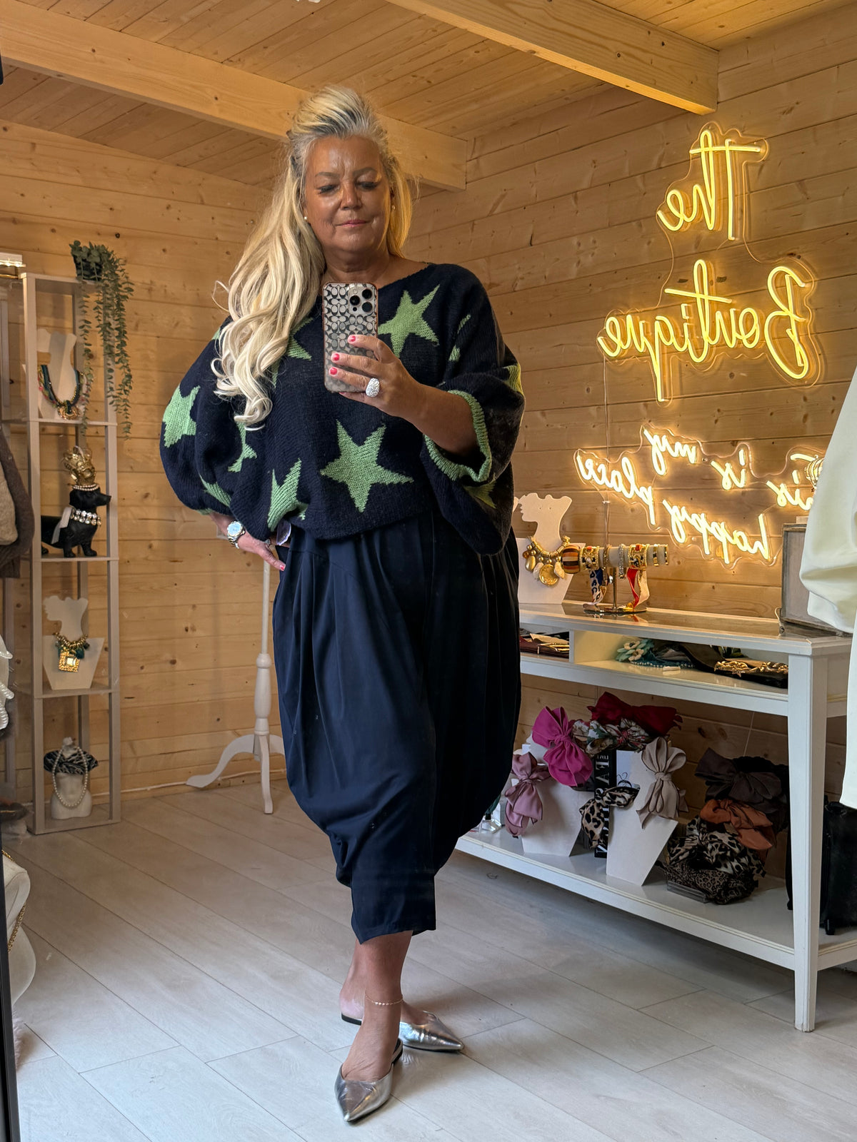 Full-length outfit view of Vega navy and green star jumper with Plain Slouch Trousers