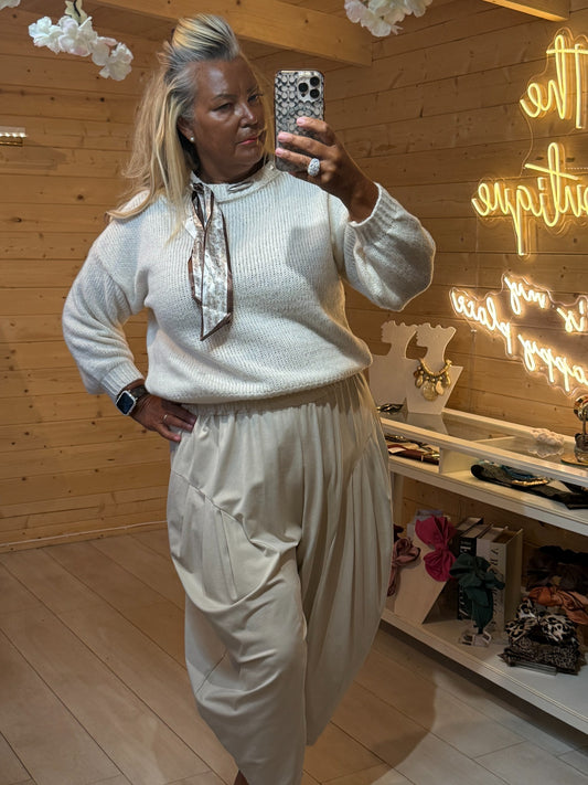 Cream Arden knit jumper front view styled with plain slouch trousers