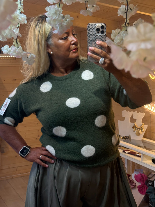Darcy khaki green jumper with oversized cream polka dots, close-up
