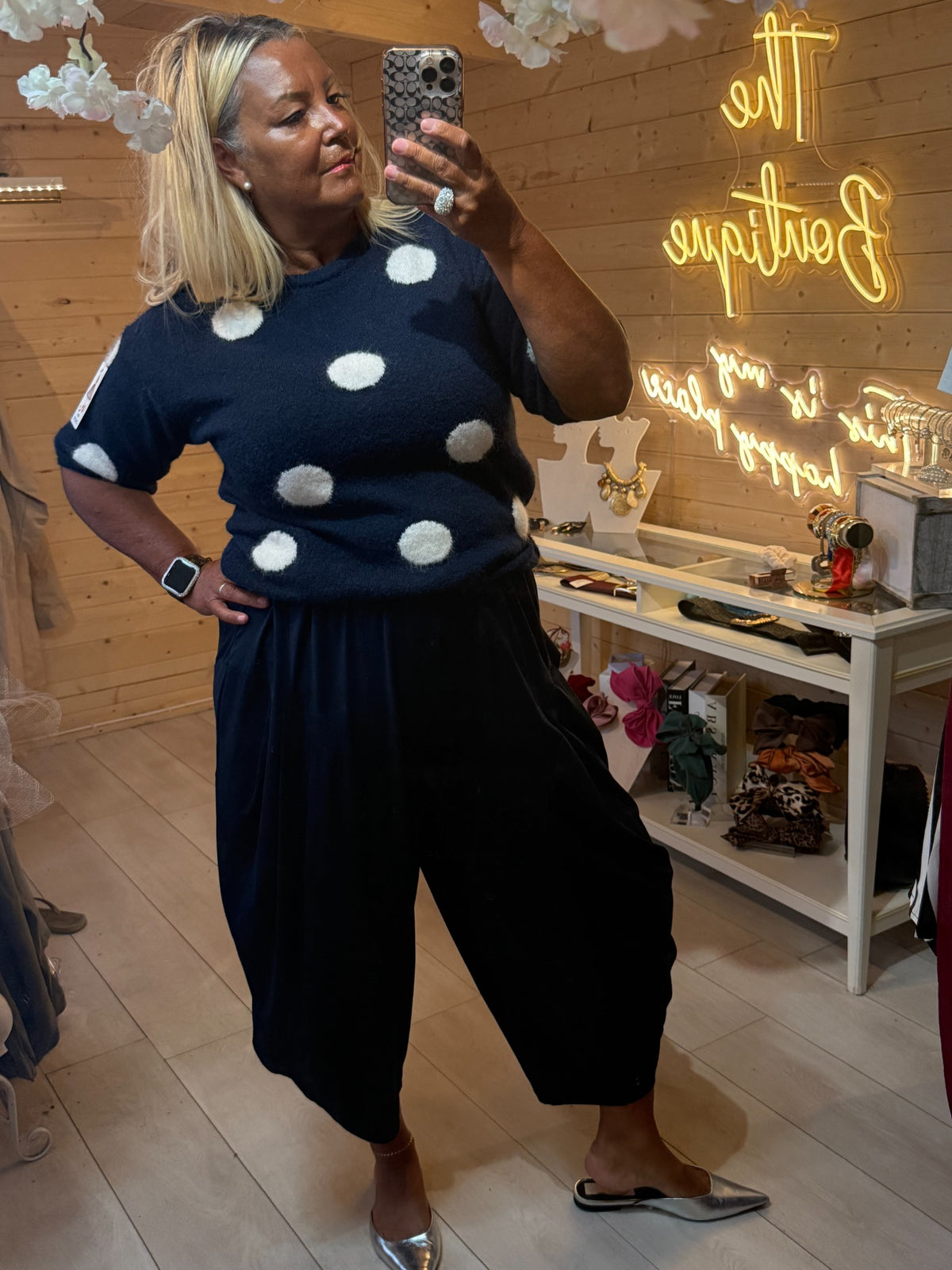 Darcy navy jumper with cream polka dots worn with black slouch trousers