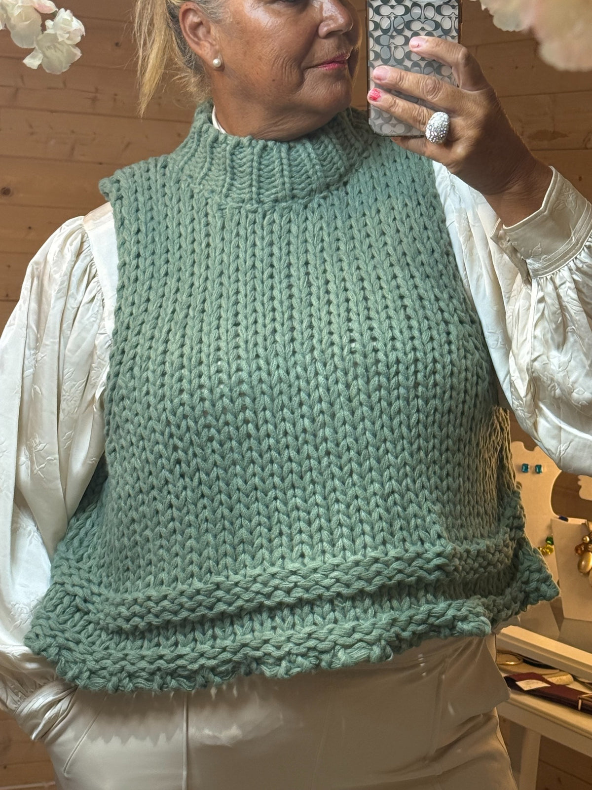 Mabel apple green chunky knitted sleeveless tank top with high ribbed neck styled over cream blouse