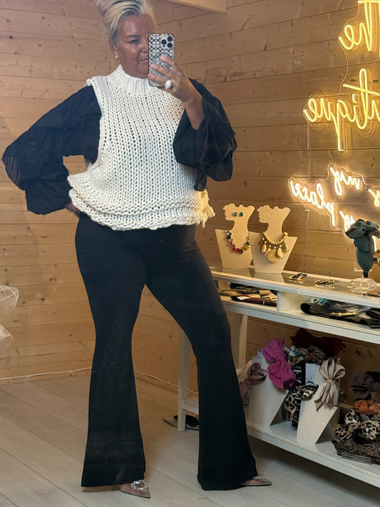 Cream Mabel chunky knit tank with ribbed high neck styled with black flared trousers