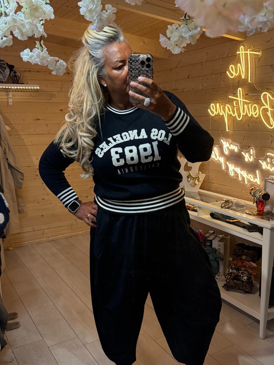 Monroe black Los Angeles 1983 varsity jumper with striped cuffs and hem, front view