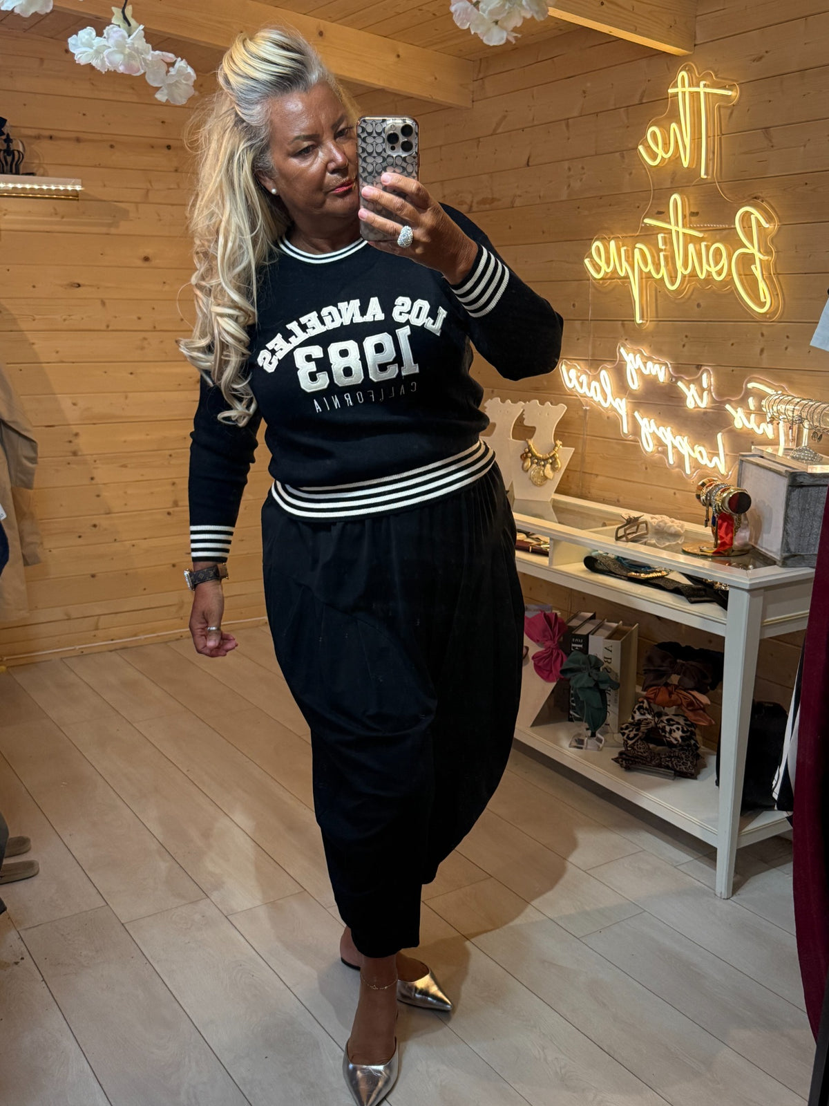 Black Monroe varsity jumper styled with black slouch trousers