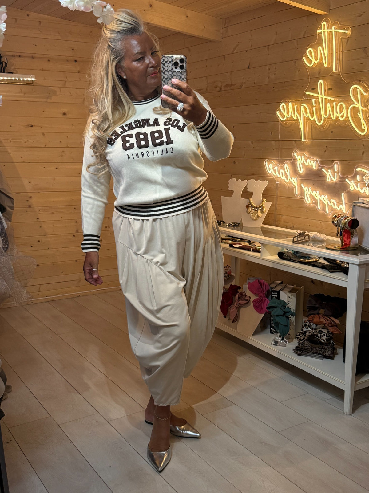 Cream Monroe Los Angeles 1983 varsity jumper styled with cream trousers