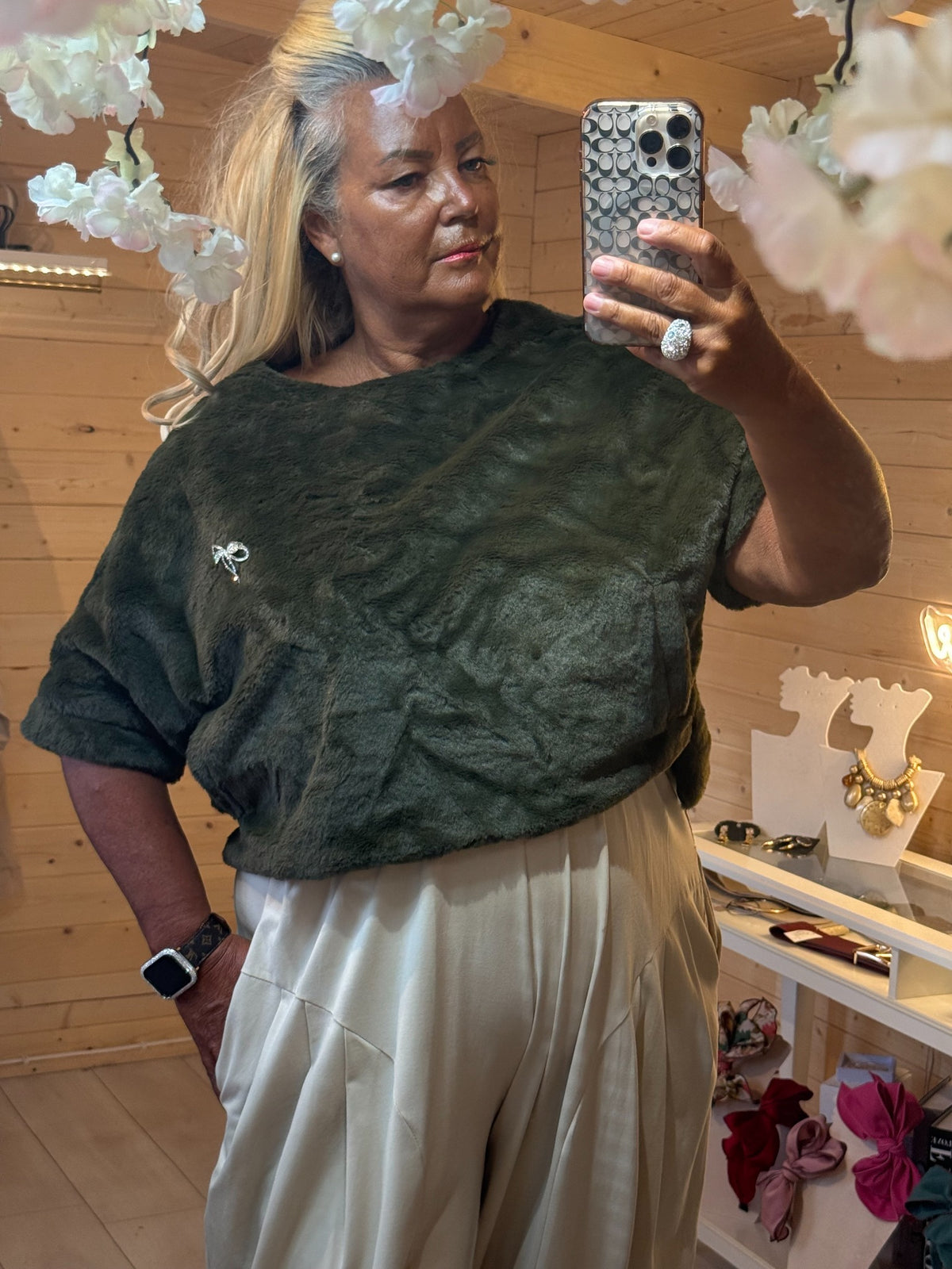 Khaki green Orla faux fur jumper with removable diamante bow brooch front view