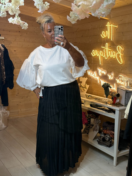 Orla white relaxed ladies top with dramatic puff balloon sleeves styled with black pleated skirt