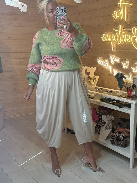 Rosella sage green rose sequin jumper styled with cream trousers, front view