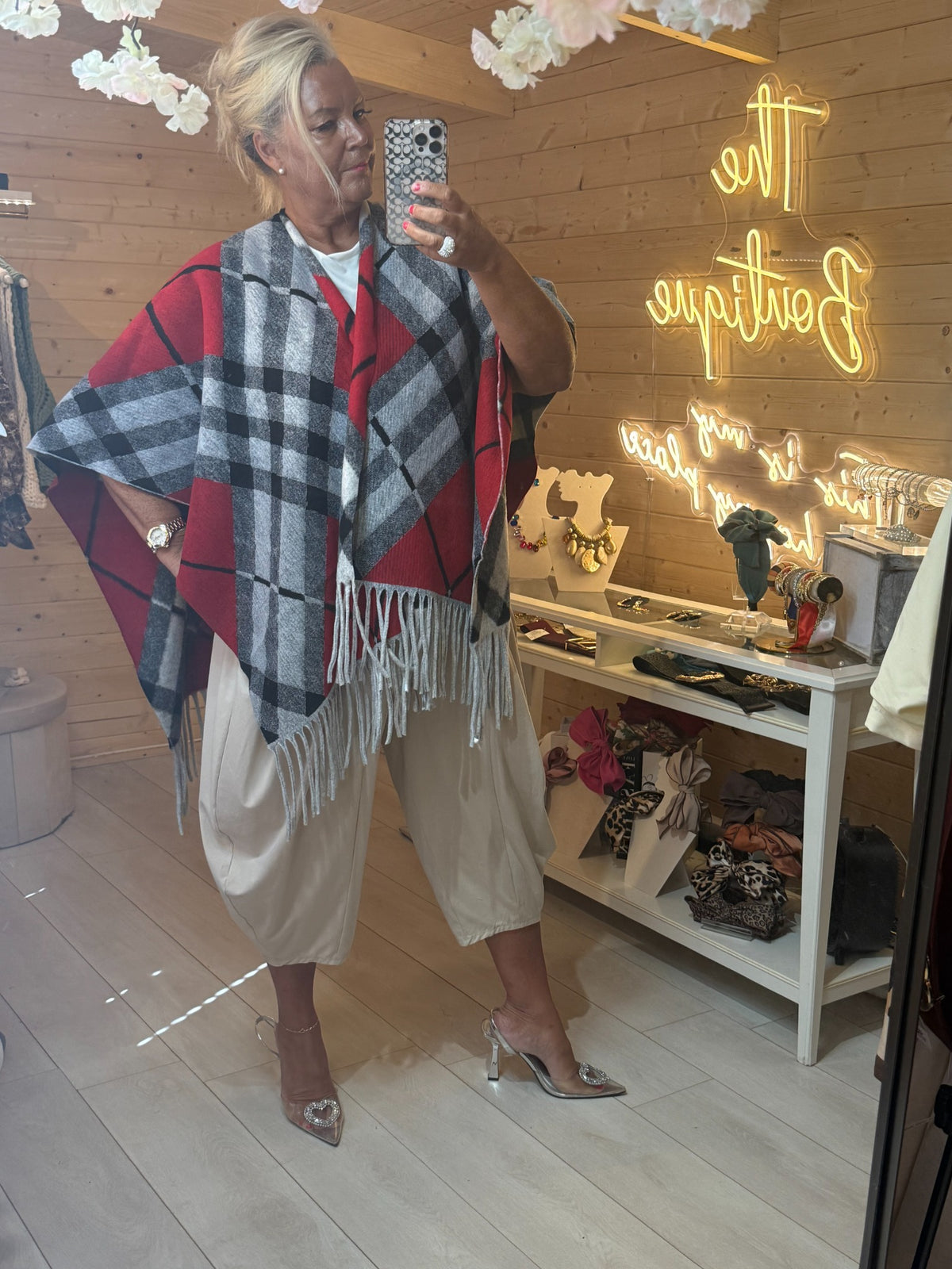 Roxie checked one size cape wrap worn open at the front showing draped design
