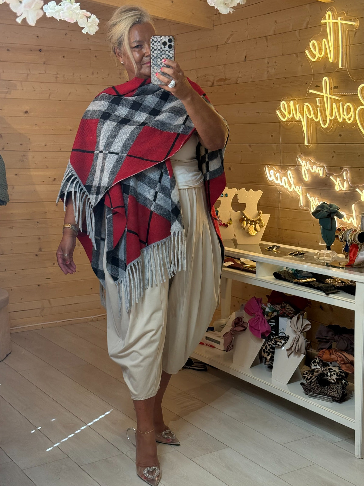 Red grey black checked oversized wrap with grey fringe trim in a front fashion pose